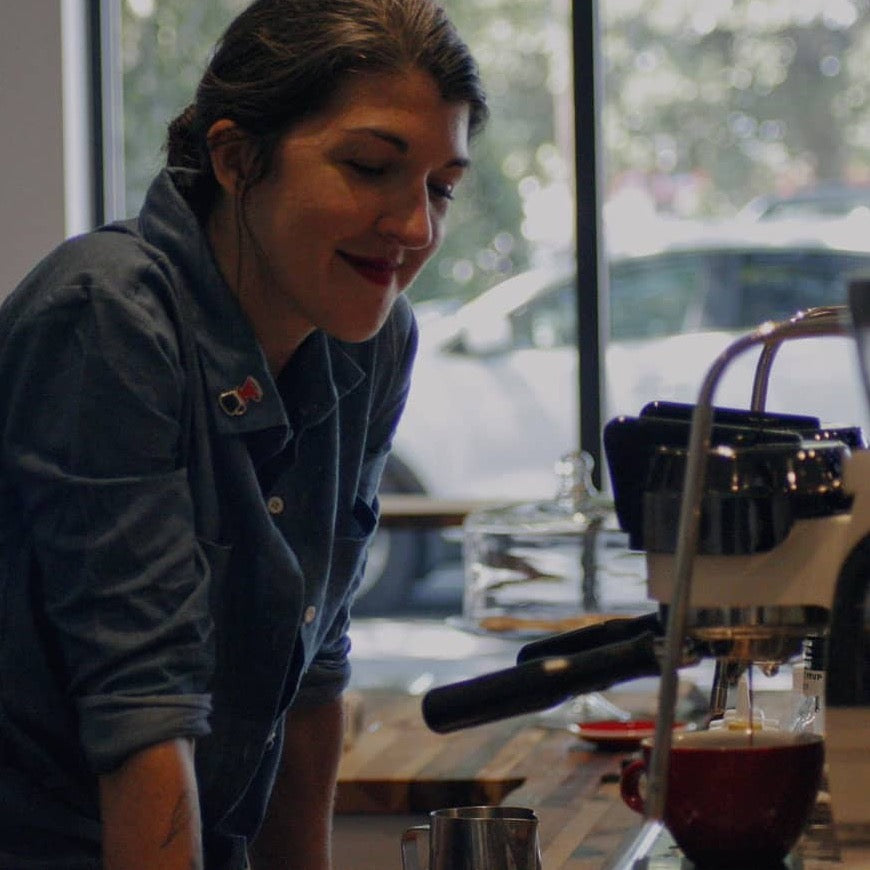 barista brewing coffee in coffee shop during classroom session