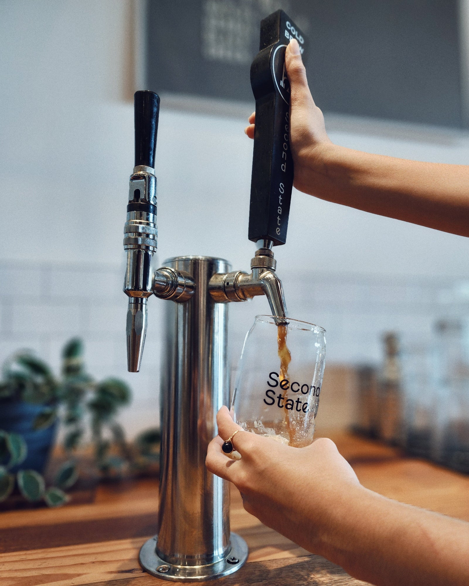 cold brew coffee poured into glass in specialty coffee shop