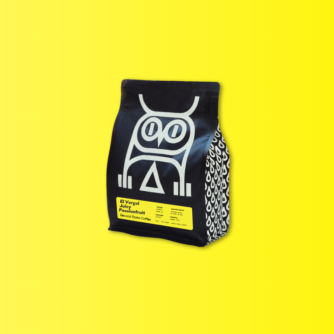 Black second state coffee bag with white owl design on a yellow background featuring colombia specialty coffee coferment